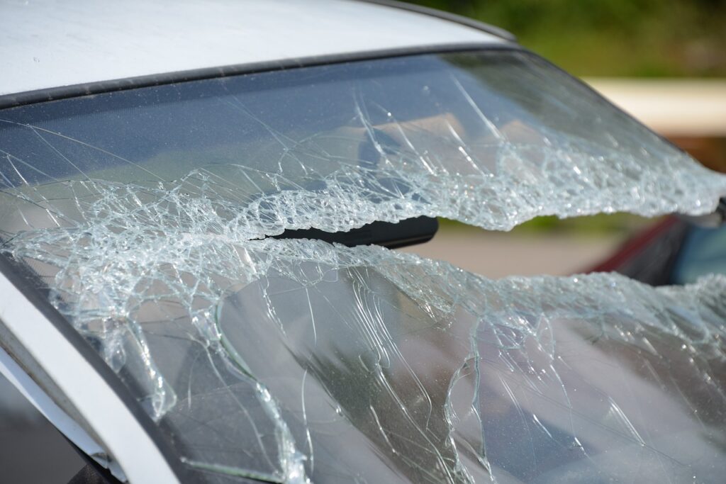 Zerbrochenes Autofenster mit deutlichen Rissen und Scherben.